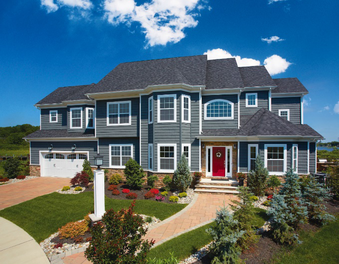 An image of a gray home with a driveway